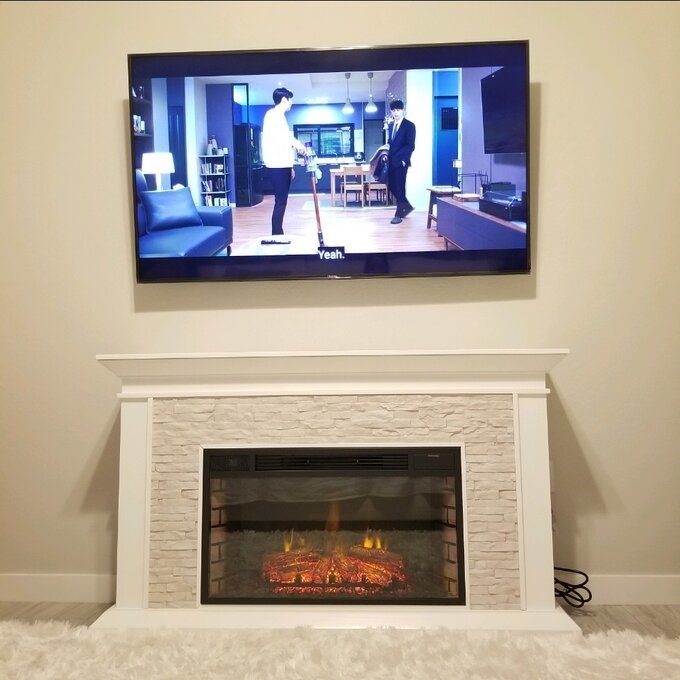 a reviewer photo of the fireplace in white
