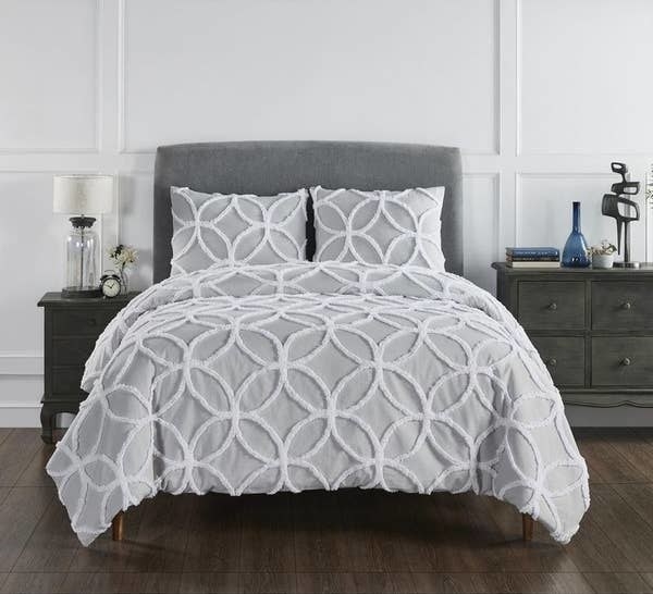 the gray and white tufted comforter