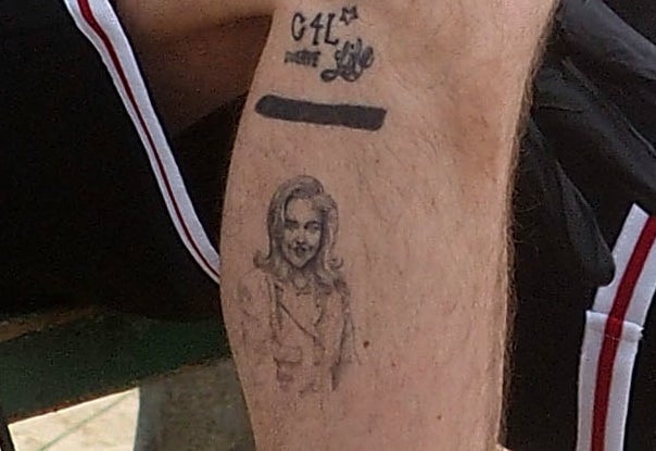 A closeup of the tattoos described