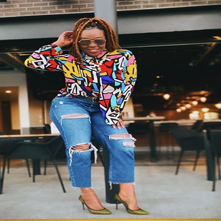 Reviewer wearing the red and yellow mixed color button-down top