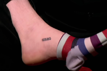 A tattoo on someone's foot that just says Greg