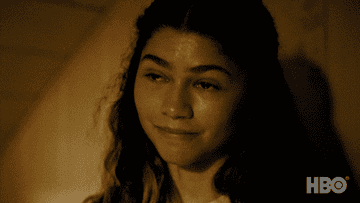 Zendaya smiling and nodding with tears in her eyes