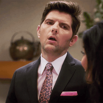 Adam Scott as Trevor, throwing his head back and groaning