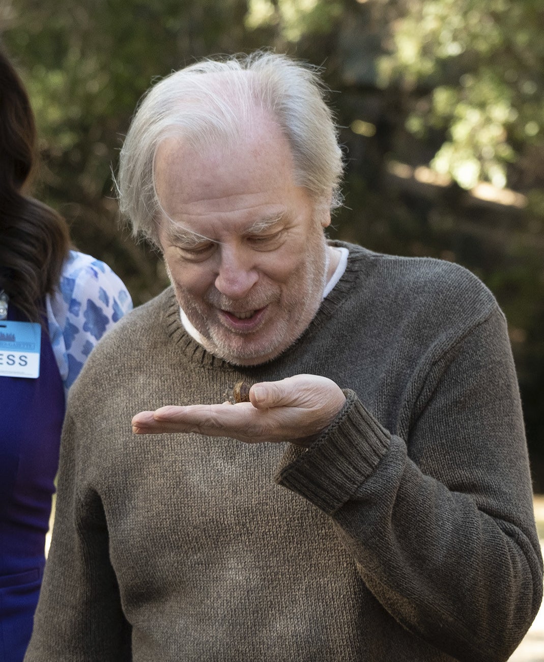 Michael McKean as Doug Forcett, talking to a snail he holds in his palm
