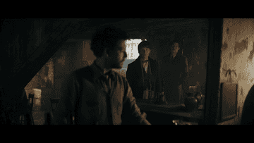 man behind bar turning around