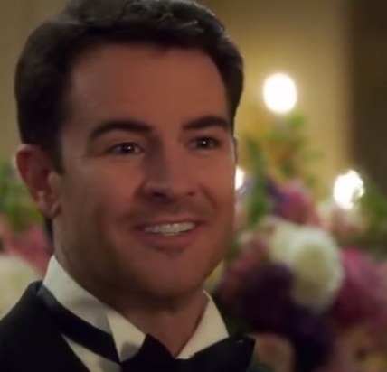 Larry Hemsworth smiling at a black tie event
