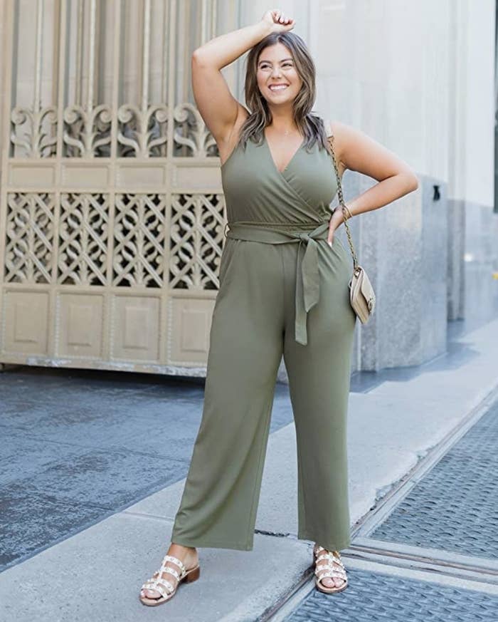 A model wearing a sleeveless wrap jumpsuit in olive