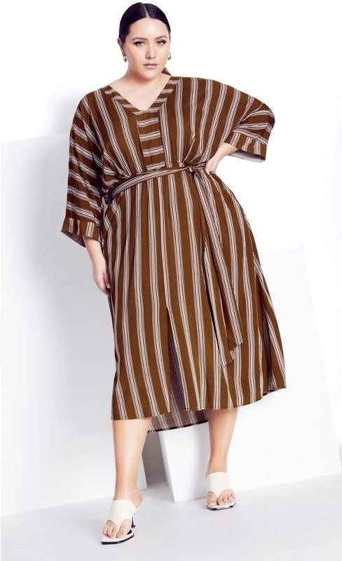 model wearing the dress with burgundy and beige vertical stripes