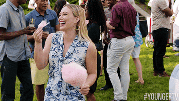 Hilary Duff eats candy floss happily at a garden party