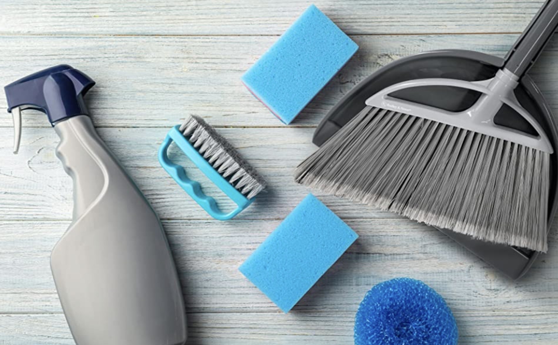 The grey broom and dustpan shown with other cleaning supplies