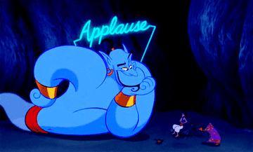 The Genie from Aladdin under a neon sign that says applause