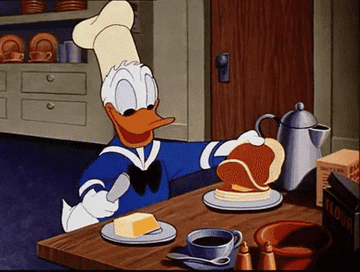 Donald Duck buttering pancakes