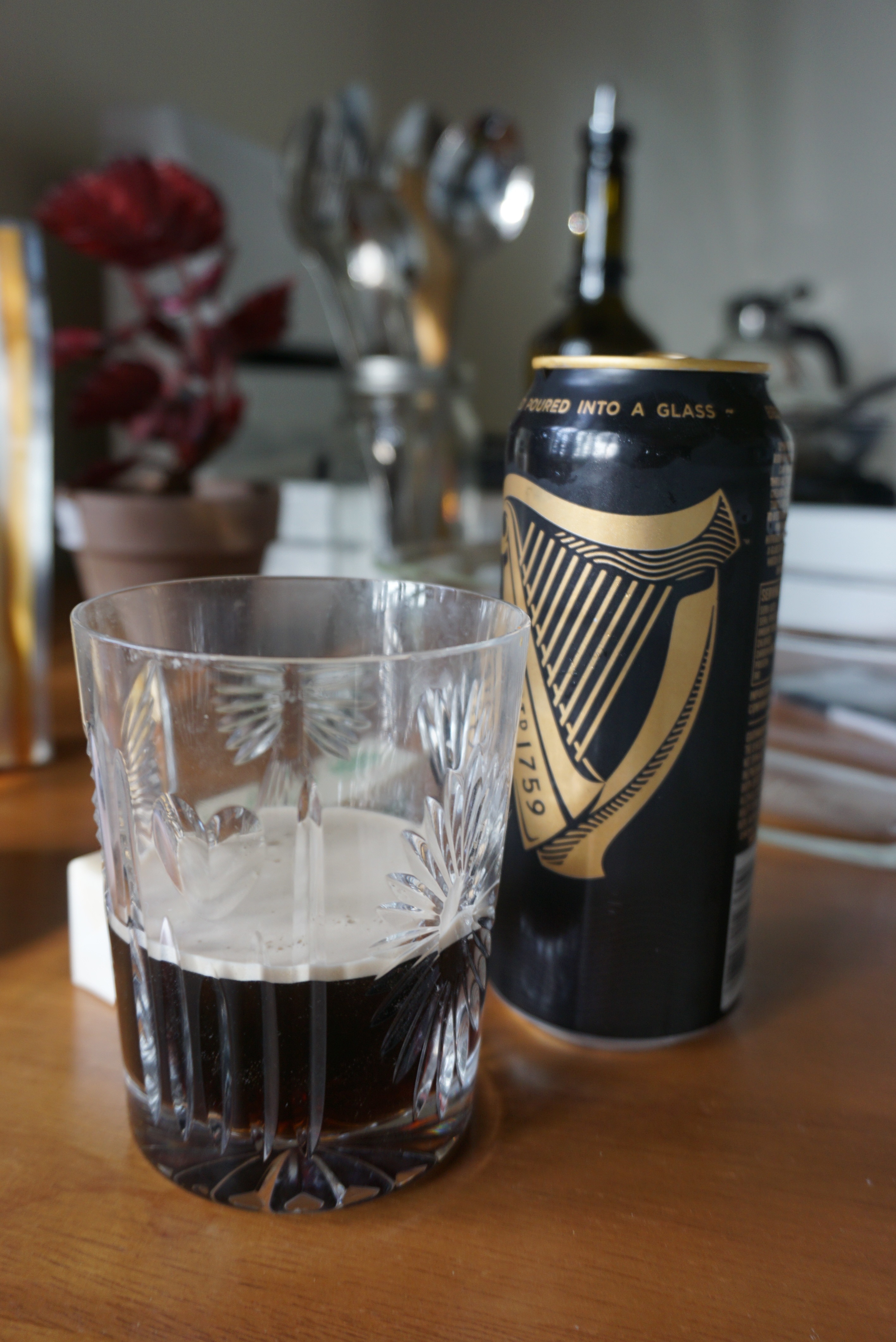 Guinness beer in a glass next to the can