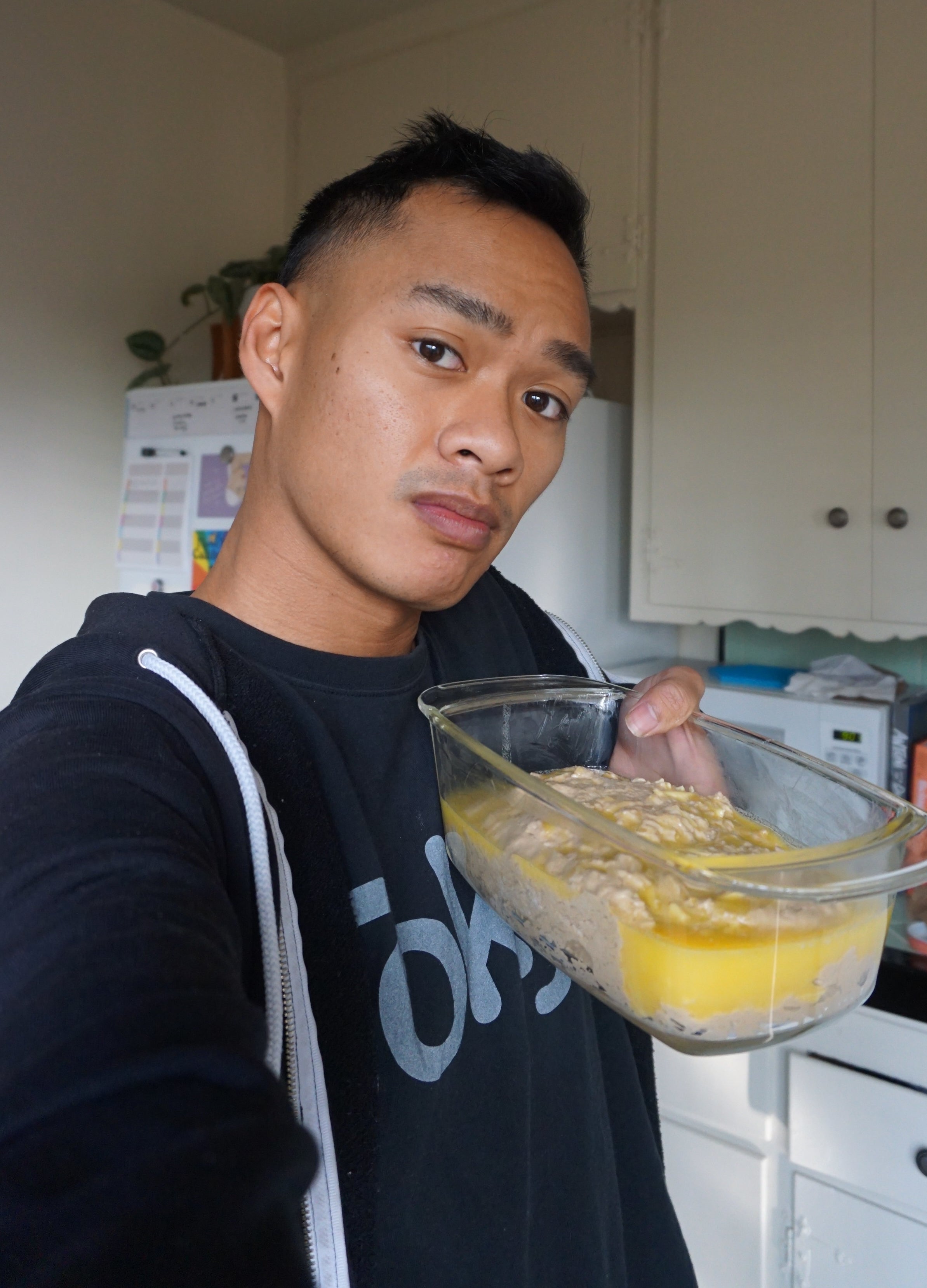 Author holding a loaf pan full of butter, with a side of dough