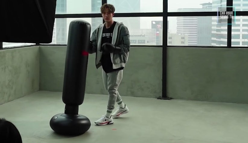 Hyun-seung looks at the camera as he does a boxing photo shoot