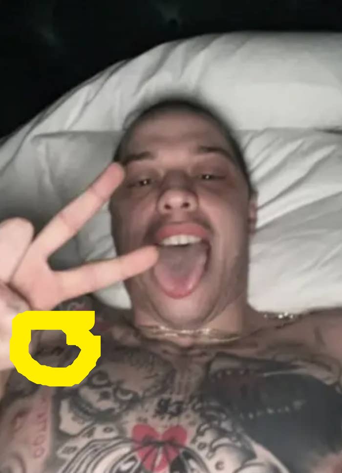 A selfie of Pete lying in bed, with a circle drawn around a tattoo that appears to say Kim