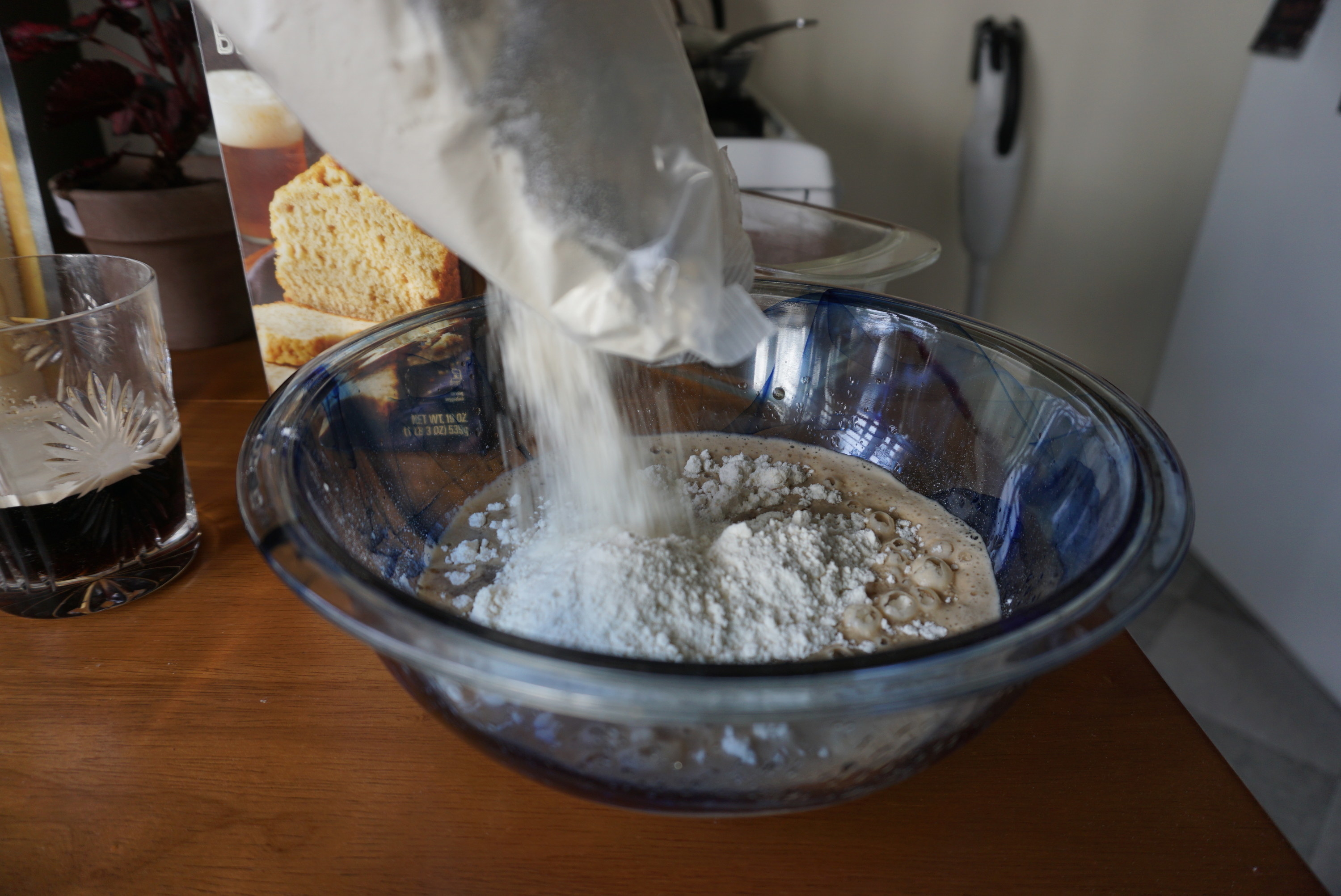 Author aggressively dumping flour into a mixing bowl