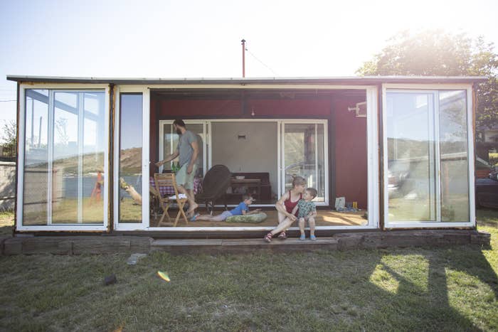 Young family hanging out in their shipping container home