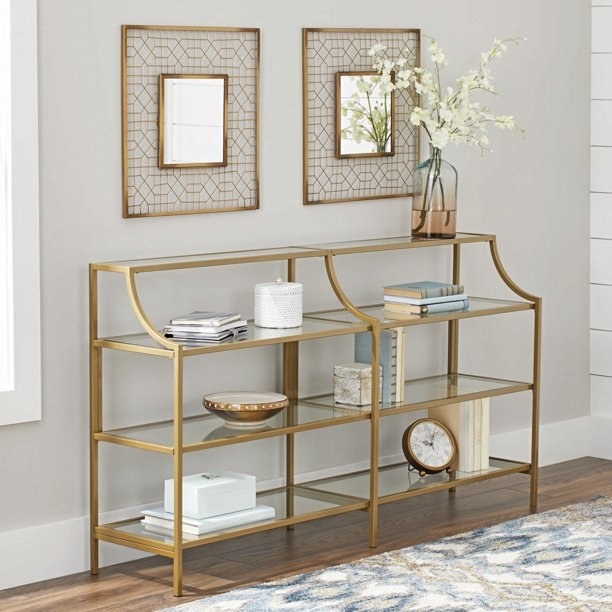 tall glass console table with a gold finish