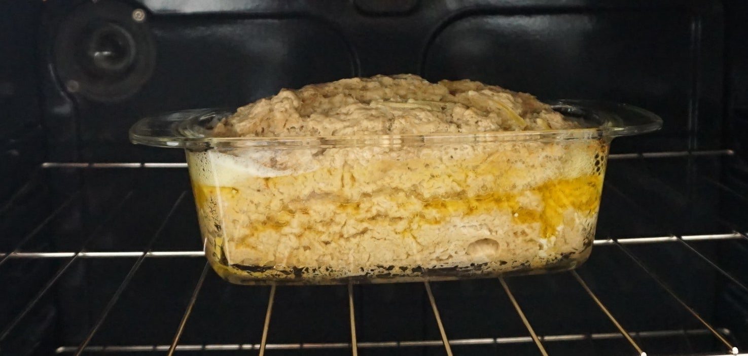 Dough rising in a loaf pan in the oven