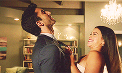 Jane pulling Rafael by his tie into a kiss while laughing