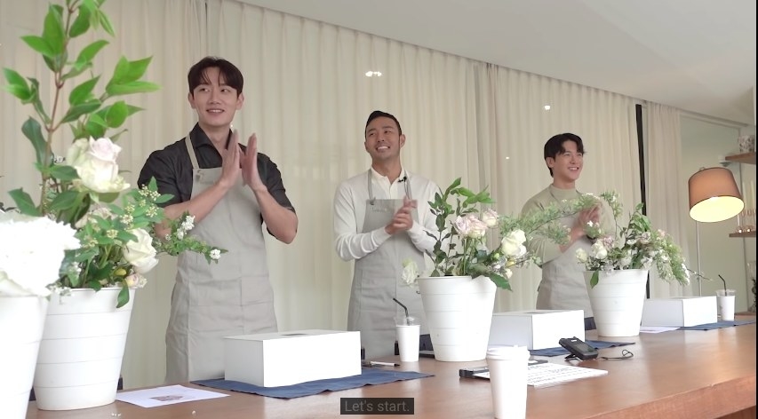 Hyeon-joong, Jin-taek and Jun-sik clap in aprons with flowers before them