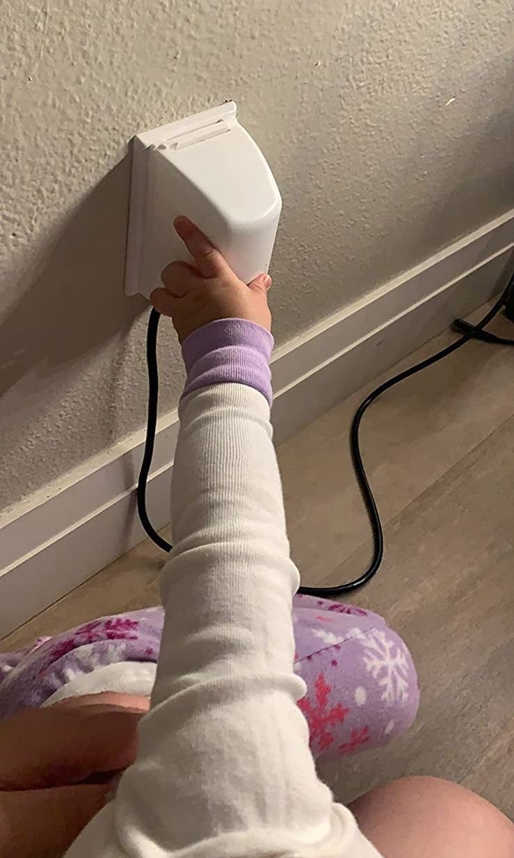 reviewer's child trying to open the outlet box