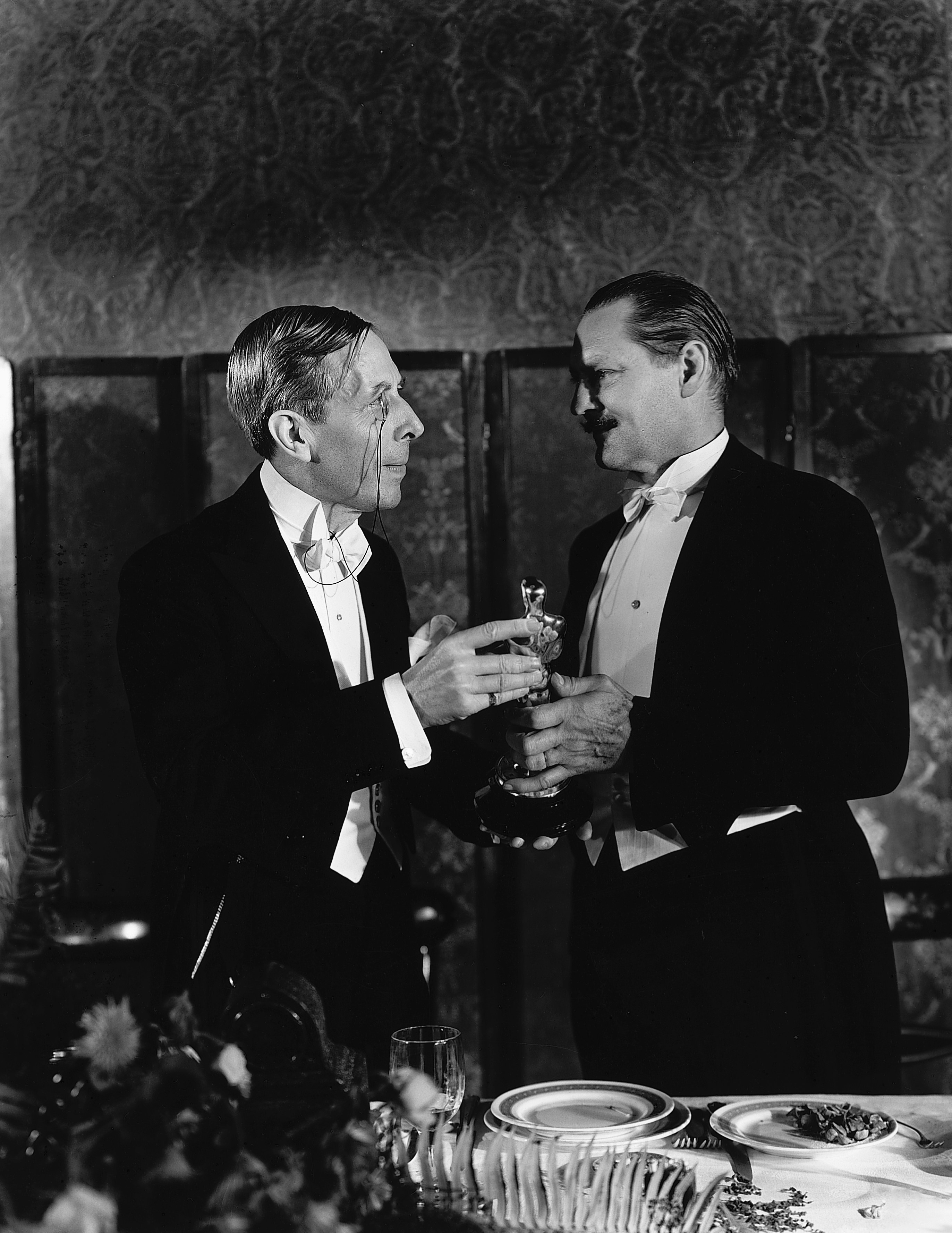George Arliss holding Best Actor Oscar 1930