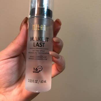 Reviewer holding the Make It Last Milani three-in-one setting spray and primer