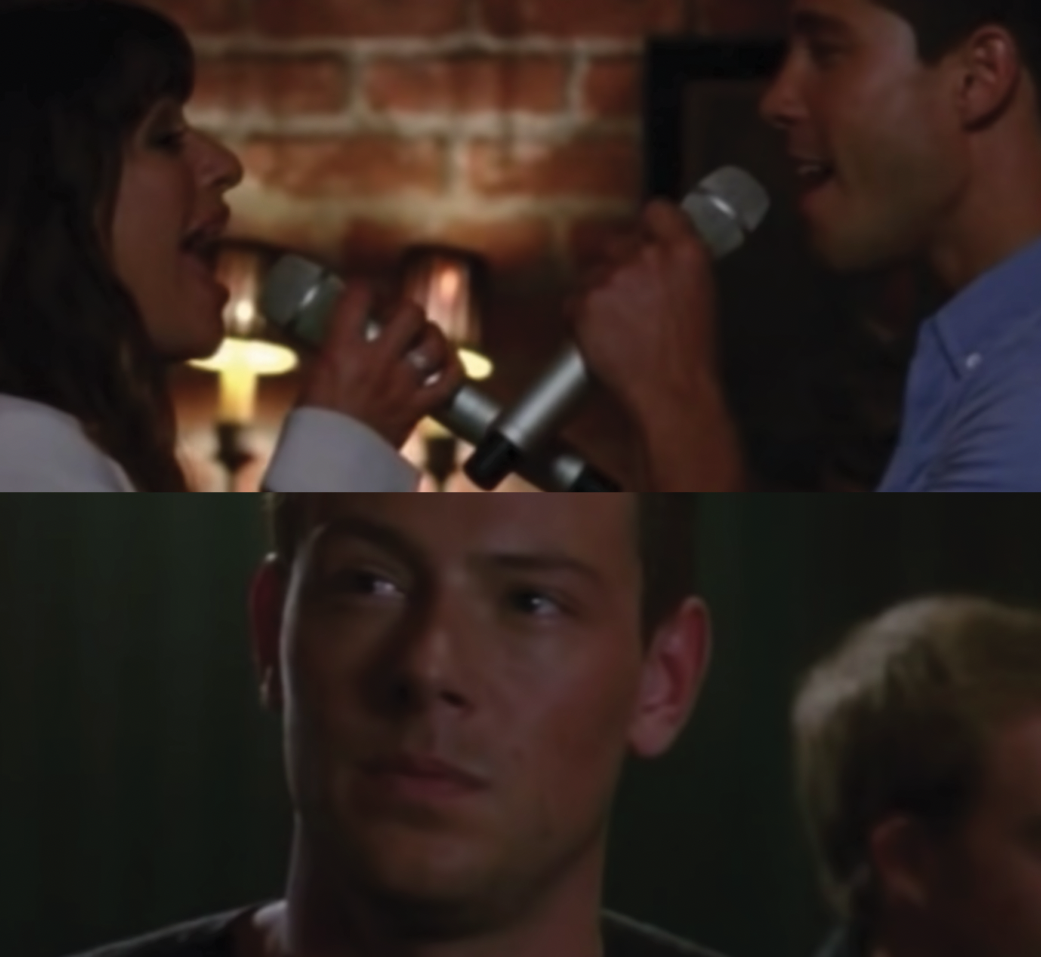 Rachel Berry and Brody Weston sing on stage together while Finn Hudson watches from the audience