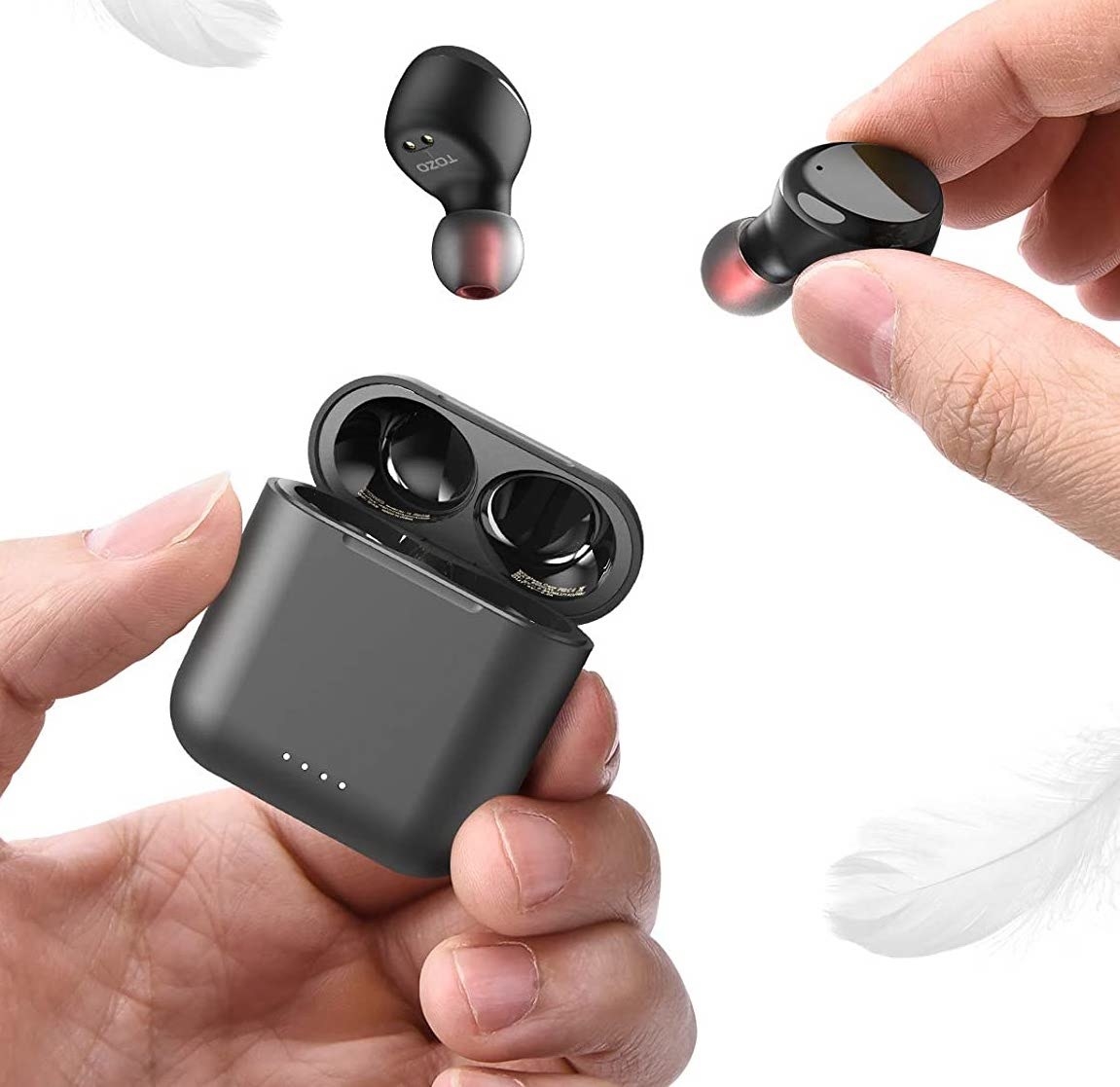 pair of hands holding the black earbuds and their case
