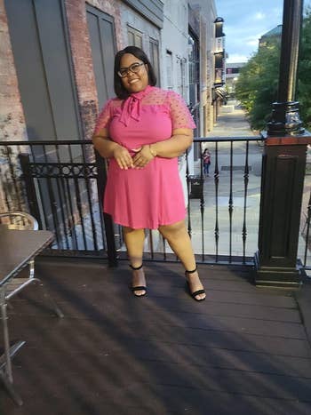 Reviewer wearing pink dress