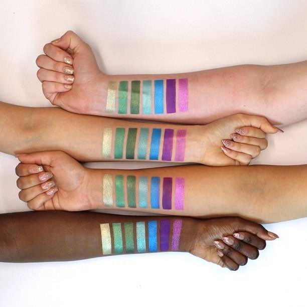 Models of four different skin tones with swatches on them