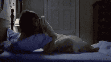 Regan in a shaking bed in The Exorcist