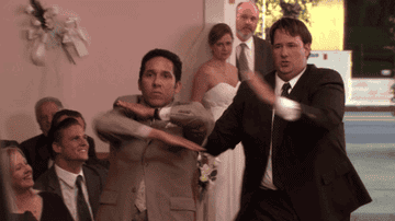 Oscar Nunez as Oscar and Brian Baumgartner as Kevin dancing down the isle at Jim and Pam&#x27;s wedding in The Office