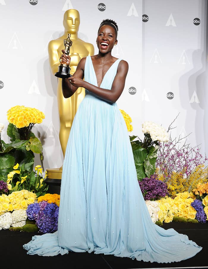 Nyong&#x27;o holding her Oscar in 2014