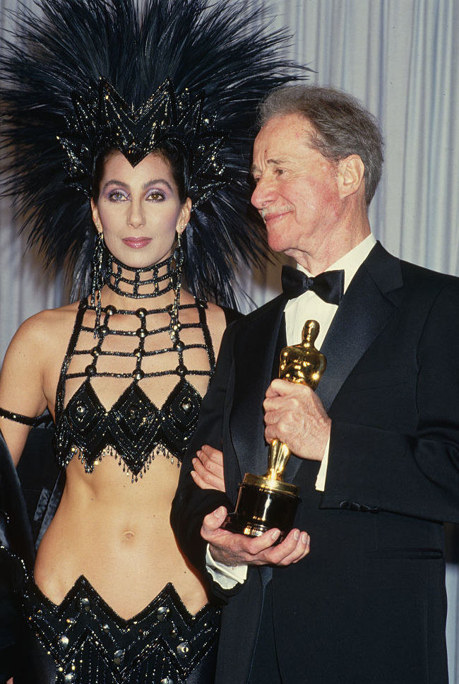 Cher in a headdress and black, revealing dress at the &#x27;86 Oscars
