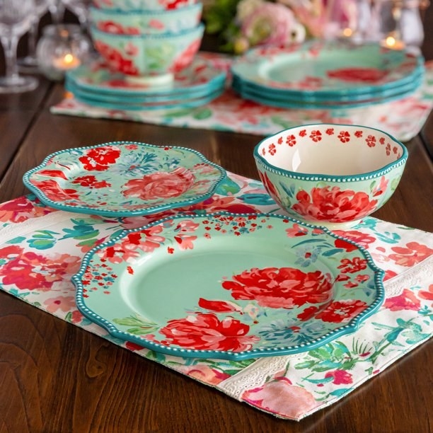 the bright floral plates on a wooden table with a coordinated placemat