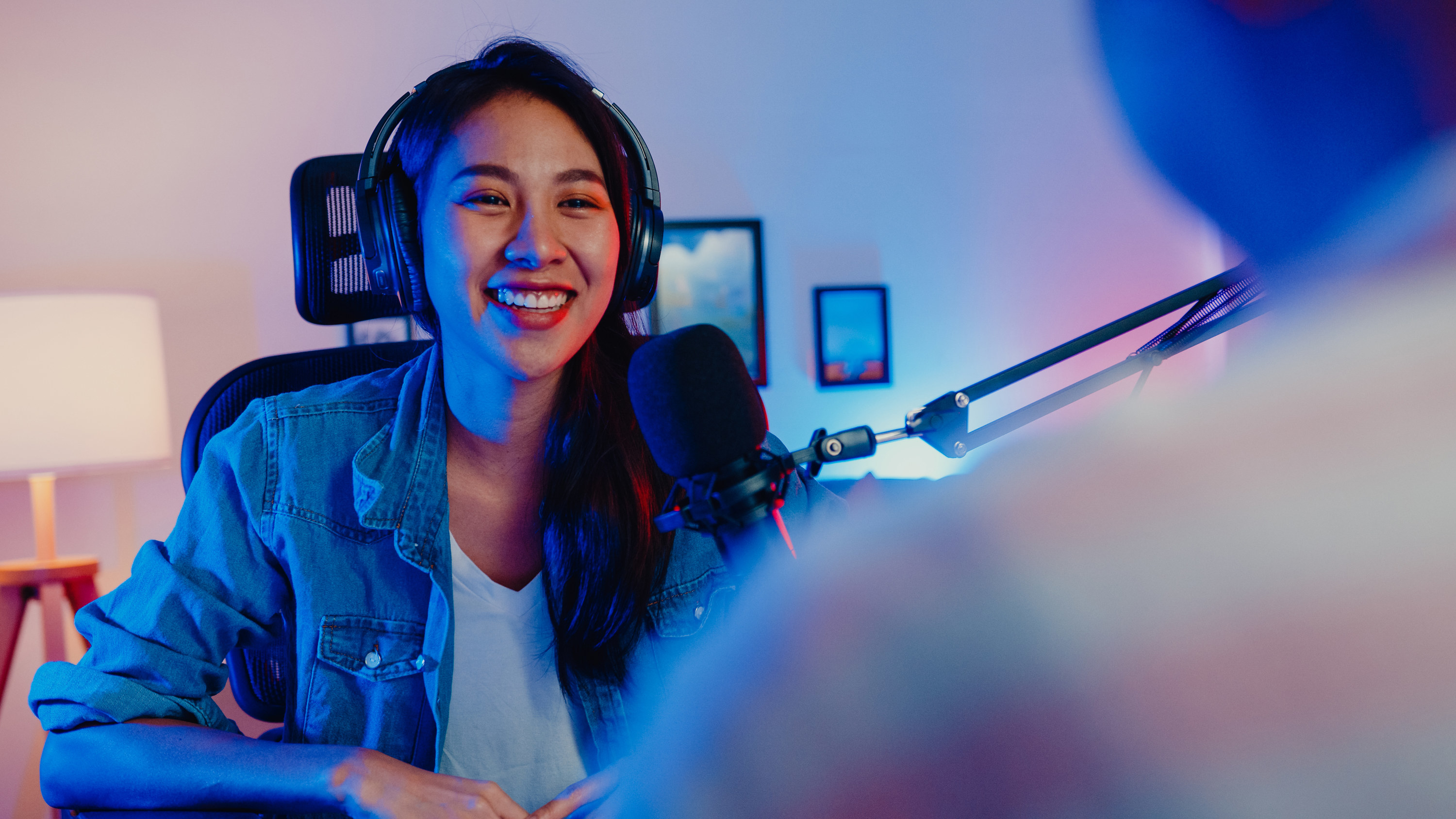 Young woman recording a podcast