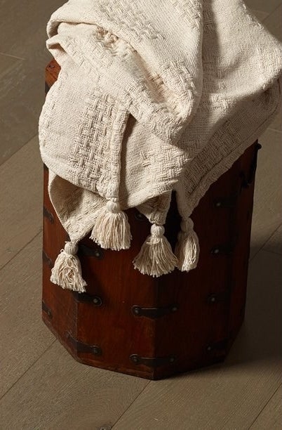 the throw blanket draped over a chest