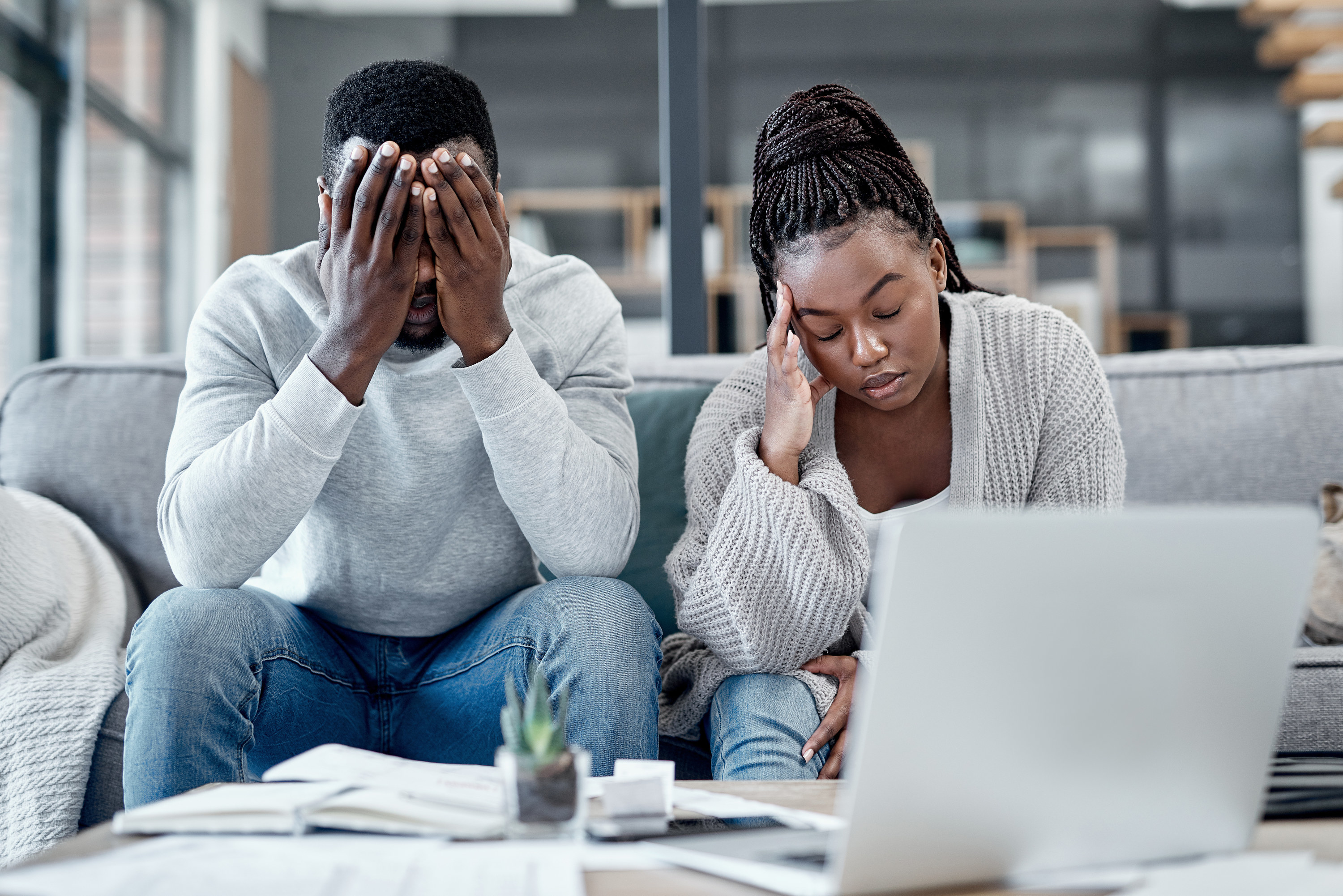 Shot of a young couple looking stressed while working on their finances at home