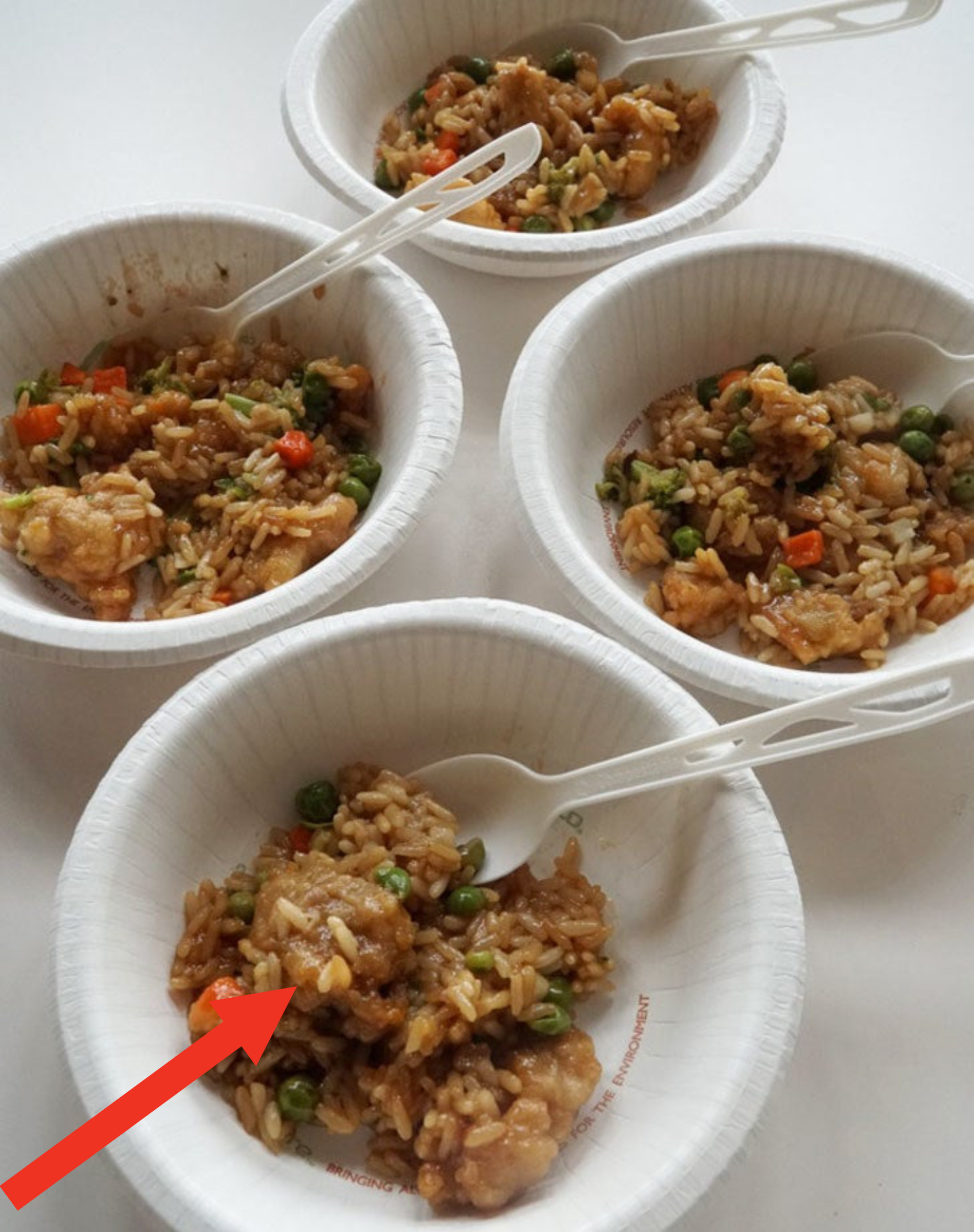 Bowls of Mandarin orange chicken over vegetable fried rice