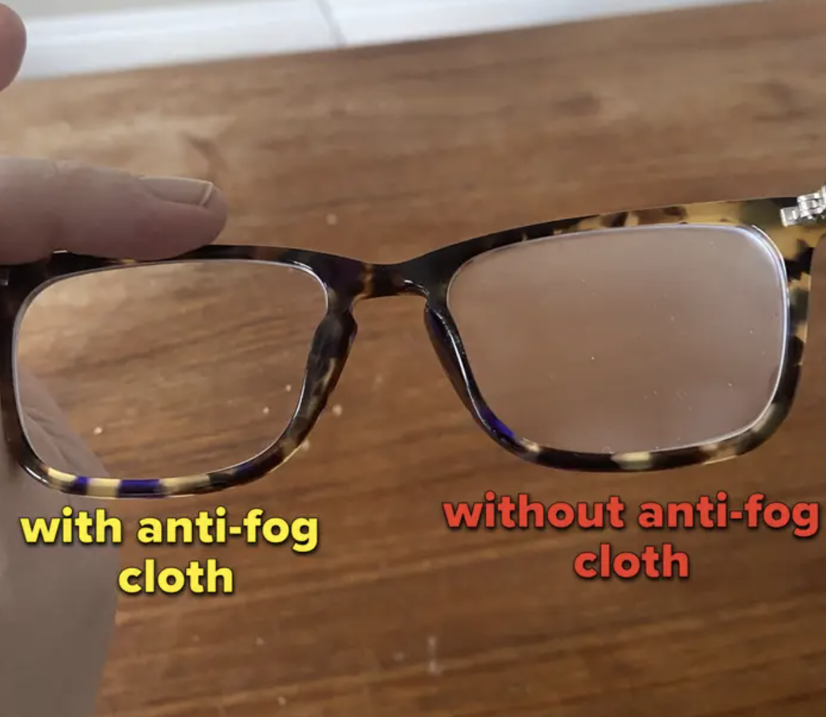 Someone holding a pair of glasses to compare anti-fog cloth effects on one lens and no fog cloth on the other