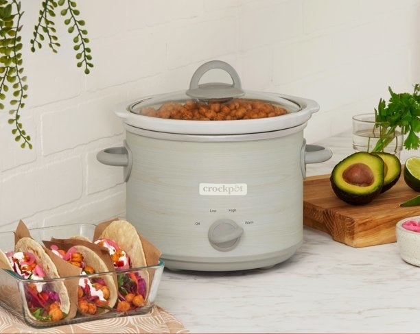 the lightly patterned crock pot on a counter with tacos