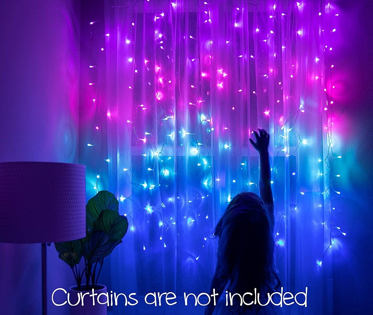 the curtain lights hanging from a curtain rod; a child is reaching for the lights