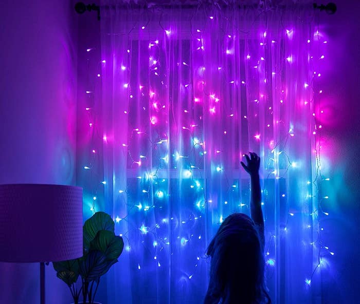 the curtain lights hanging from a curtain rod