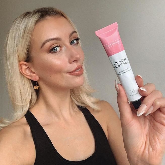 a model holding up a tube of ultraglide face primer