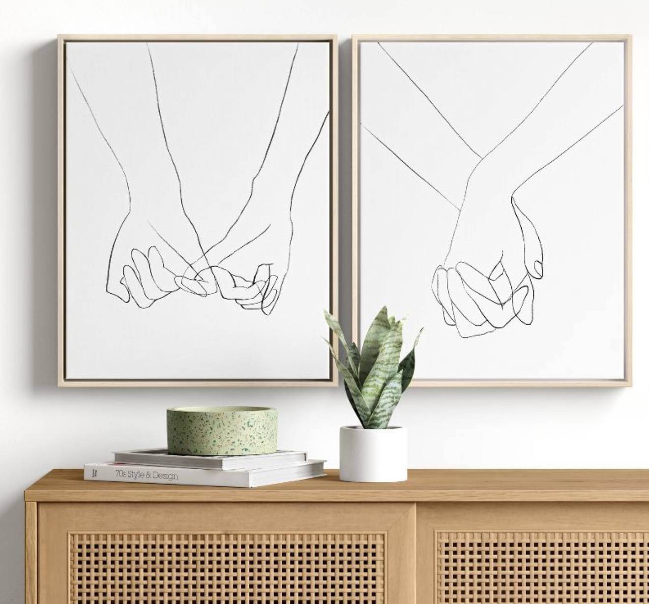 the two canvas prints with drawings of holding hands