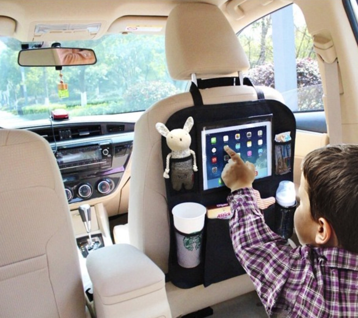 A child using the backseat organizer