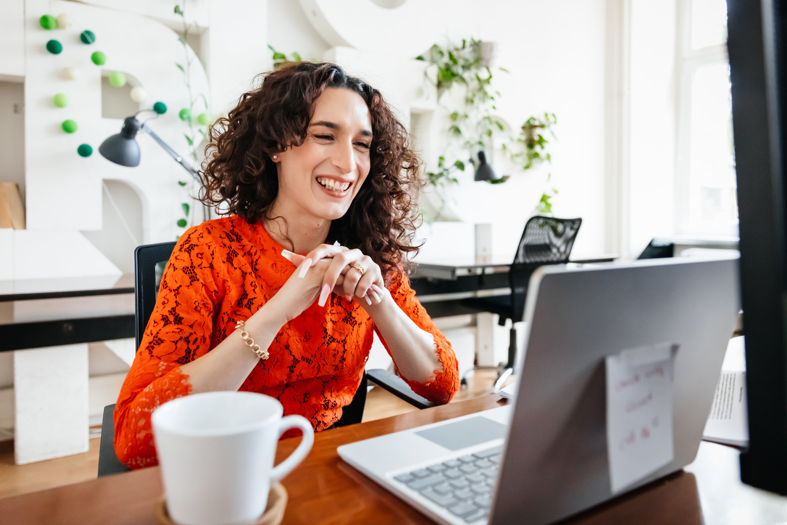 a woman smiles at her lap top